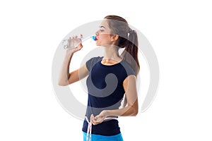 Woman with centimeter drinking water