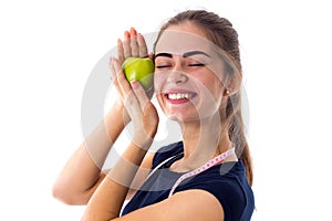 Woman with centimeter holding an apple