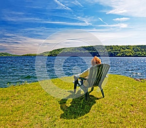 Woman in chair observing Otsego Lake in Spring