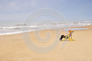 Woman in chair on sea beach