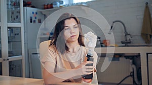 Woman changes batteries in her bionic prosthesis, close up.