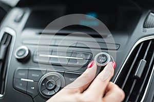 Woman changing frequency on car radio