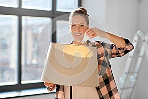 woman changing light bulb at new home