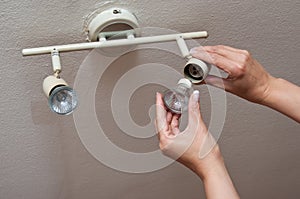 Woman changing a Light Bulb