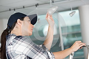 Woman changing lightbulb