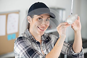 woman changing lightbulb