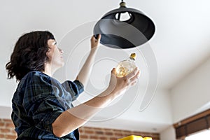 Woman changing tube light by herself