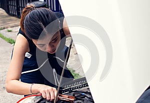 A woman is charching battery of car