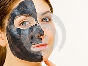 Woman with charcoal facial mask