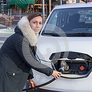 Woman charging an electric car