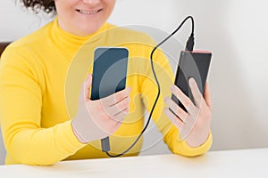 Woman charging a smartphone