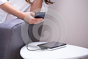 Woman Charging Smartphone Using Powerbank