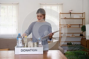 Woman with charity box. volunteer at assistance center. Charity, donation, and volunteering concept
