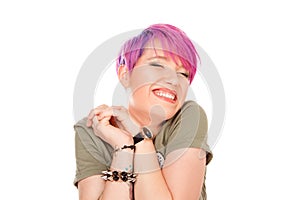 Woman with charming smile, keeps eyes closed and touches shoulder