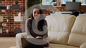 Woman chatting with mates in videocall using laptop