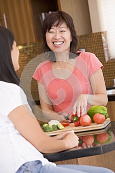 Woman Chatting To Friend While Preparing Meal photo