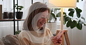 Woman chatting using mobile phone at home