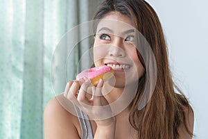 Woman cheating diet and eating doughnut. selective focus on mouth