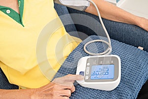 woman check blood pressure monitor and heart rate monitor with digital pressure gauge. Health care and Medical concept