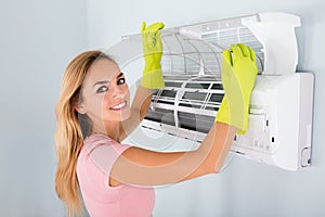 Woman Checking Air Conditioner