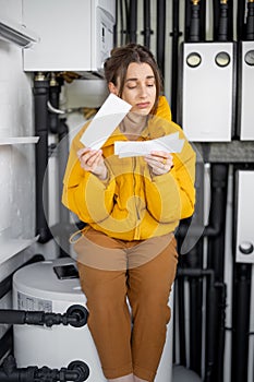 Woman checking bills for electricity at home