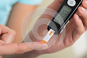 Woman Checking Blood Sugar Level