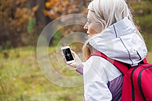 Woman checking compass app on her smartphone