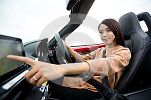 Woman checking direction on car GPS system