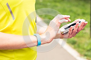 Woman checking fitness and health tracking wearable device