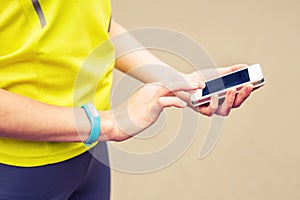 Woman checking fitness and health tracking wearable device