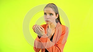 Woman checking freshness of breath. Space studio on yellow background