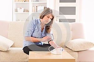 Woman checking her blood pressure