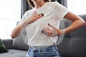 Woman checking her breasts shape