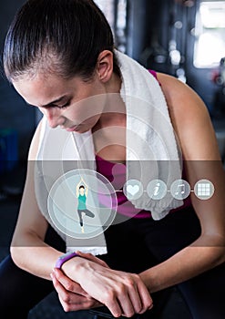 Woman checking her fitness band in gym