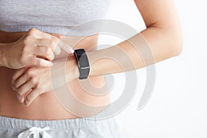 Woman checking her health tracking wearable device