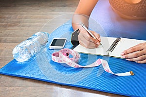 Woman checking her health after workout, Diet and Fitness