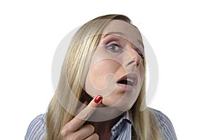 Woman checking her skin for imperfections