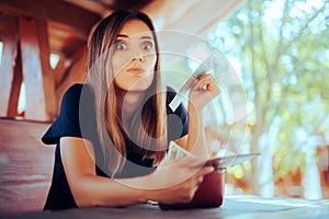 Woman Checking her Wallet to Pay in a Restaurant