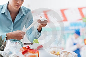 Woman checking a long receipt