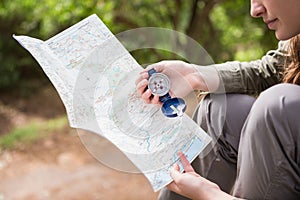 Woman checking map and compass