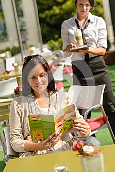 Woman checking menu waitress bringing order coffee