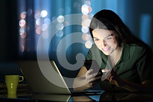 Woman checking phone in the night
