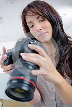 woman checking pictures in camera