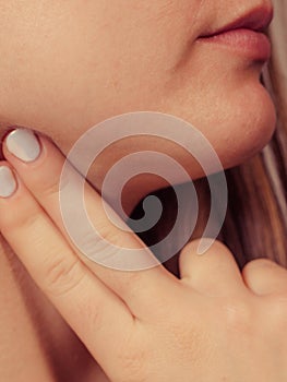 Woman checking pulse on neck closeup
