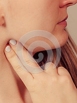 Woman checking pulse on neck closeup