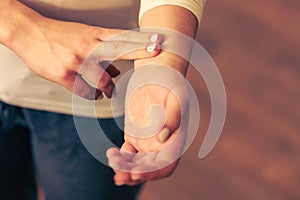 Woman checking pulse on wrist closeup