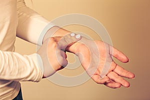 Woman checking pulse on wrist closeup