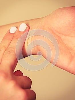 Woman checking pulse on wrist closeup