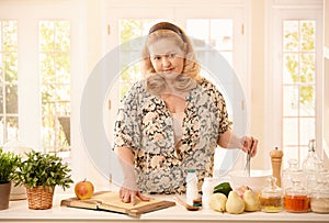 Woman checking recipe in kitchen