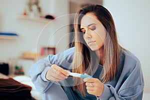 Woman Checking the Results of a Pregnancy Test at Home